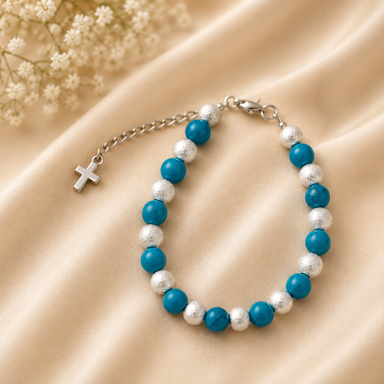 Layla turquoise and silver beaded bracelet with cross charm on champagne satin