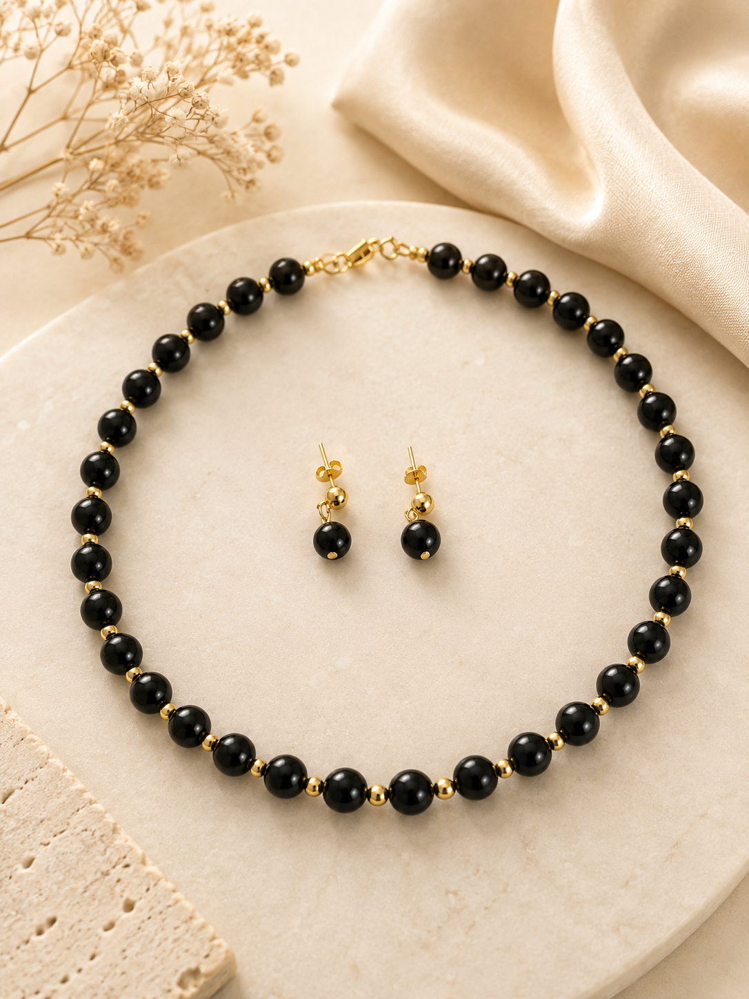 Naomi black beaded necklace and matching earring set with gold accents